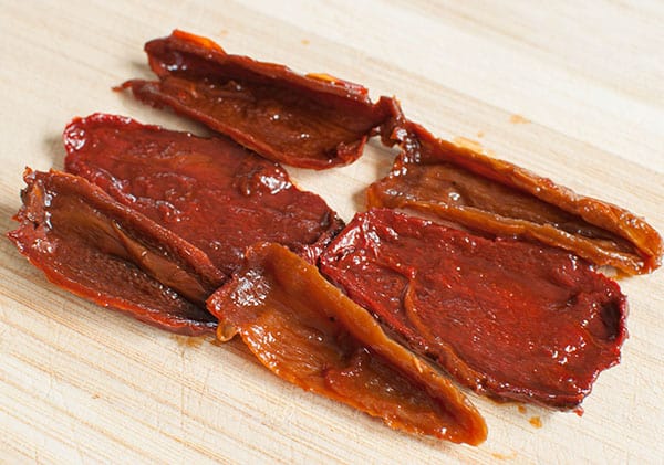 sliced chipotle peppers on cutting board for chipotle dip