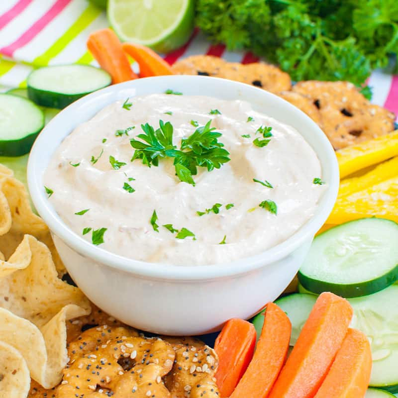chipotle mayonnaise dip in a white bowl topped with parsley