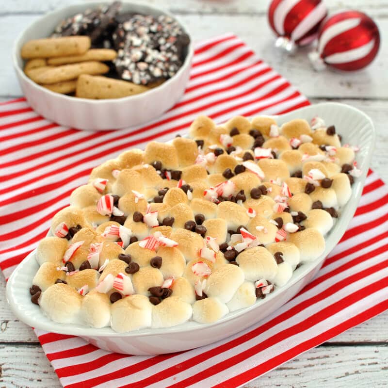 Chocolate and toasted marshmallows get a Christmas time twist with the flavor of peppermint in this peppermint s'mores dip. Great dessert for the holidays.