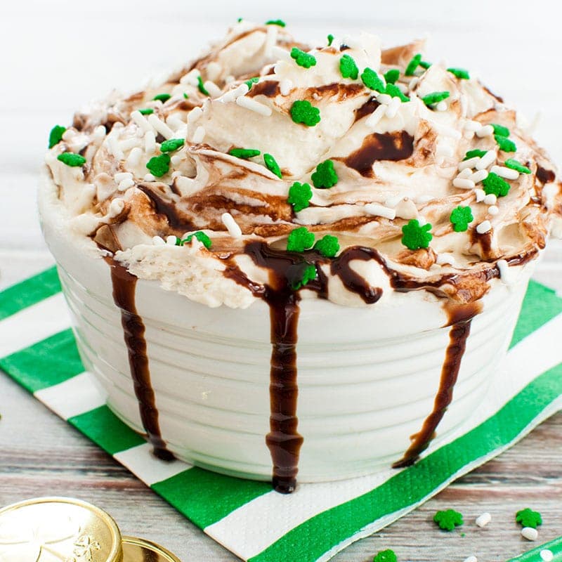 Bowl of Baileys Irish Cream Dip drizzled with chocolate and topped with festive sprinkles
