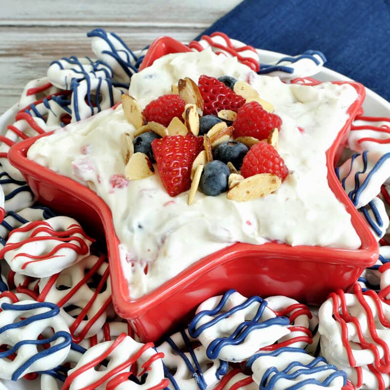 Almond Berry Fruit Dip- a festive dessert for the 4th of July. Dip combines the flavor of almond with berries and cream cheese for a patriotic and easy recipe.