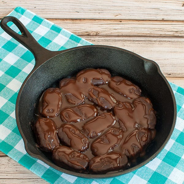 Step 1- Mounds placed in skillet covered with chocolate and caramel sauce