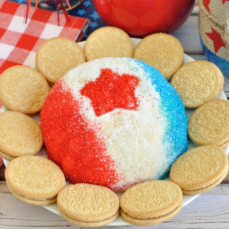 Decorated in a patriotic theme, this Red White & Blue Golden Oreo Cheese Ball is an easy dessert dip recipe for the 4th of July, Memorial Day, or Labor Day.