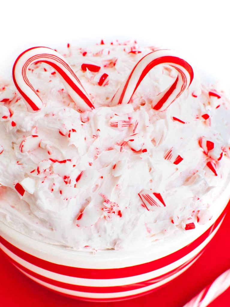 Peppermint candy cane dip with two candy canes in the middle