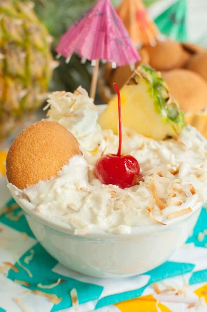 Vanilla wafer dipped into a bowl of Pineapple Dip with Coconut AKA Pina Colada Dip