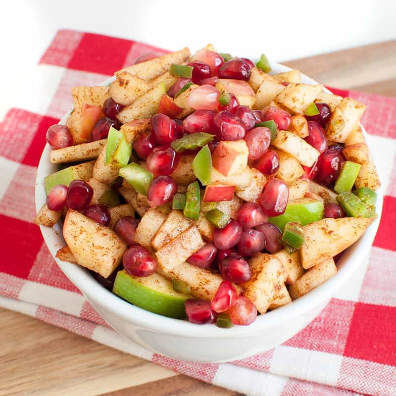 Apple Salsa with Pomegranate seeds in a bowl on a napkin
