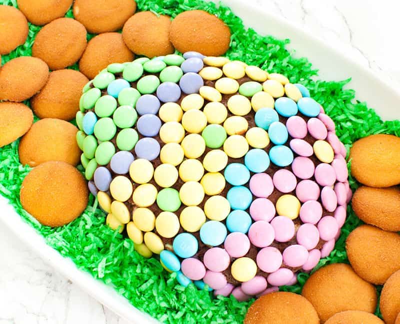 easter cheese ball dessert covered in spring M&Ms with green Easter grass
