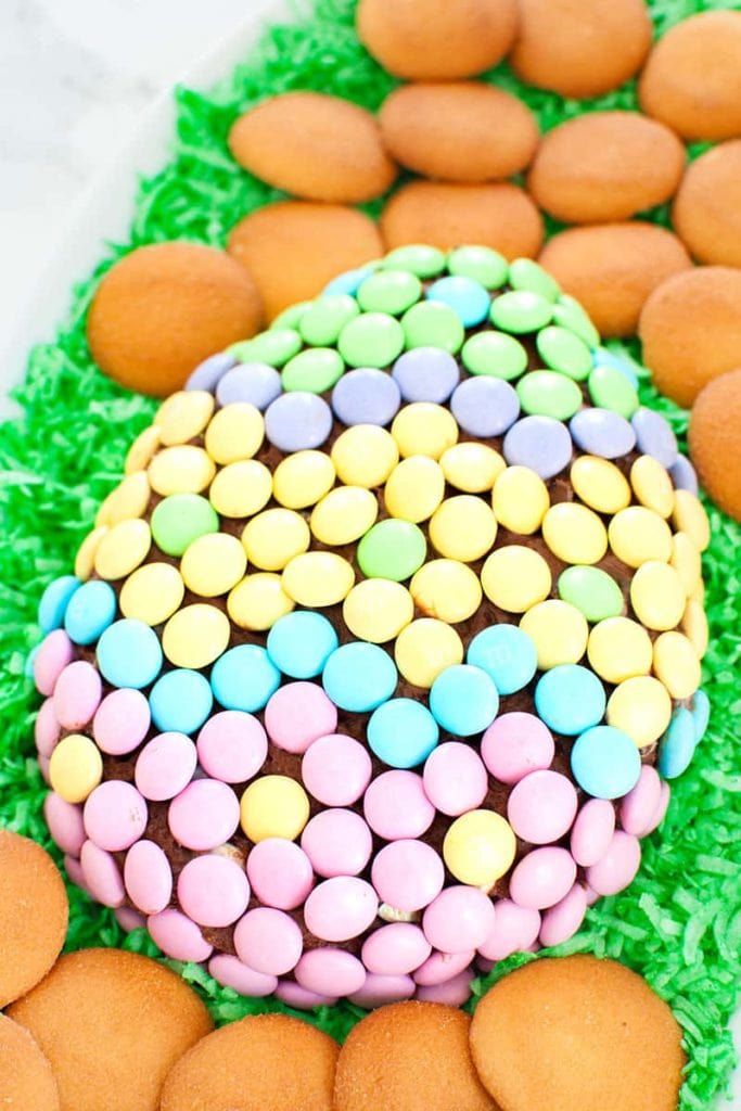 Chocolate Easter cheese ball shaped like an Easter egg covered in spring colored M&Ms