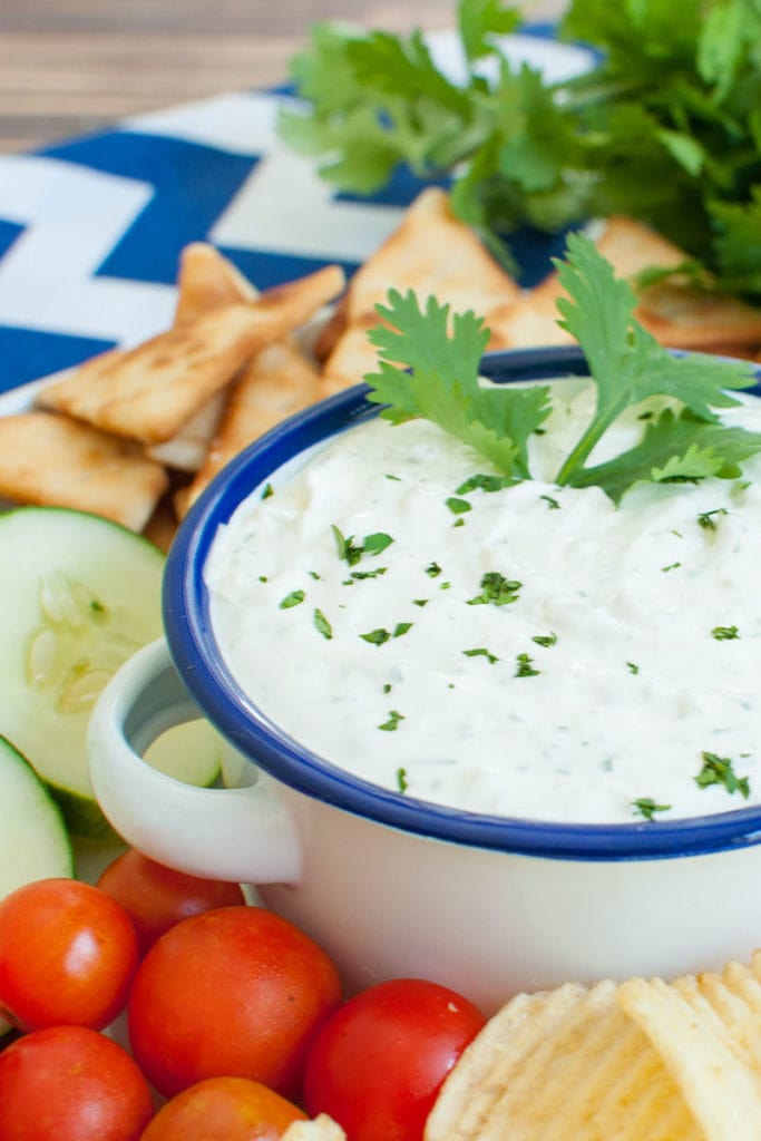 veggie and chip platter with white and blue bowl of dip