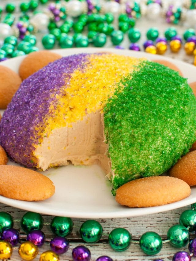 purple, gold and green colored cheese ball on plate surrounded with mardi gras beads