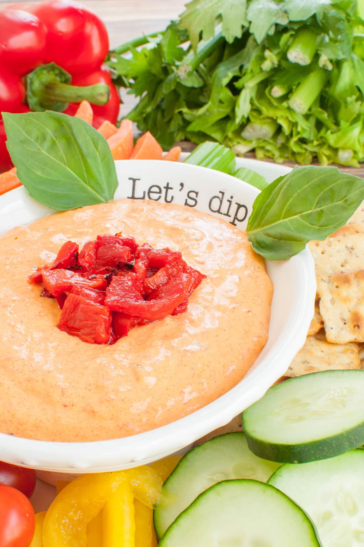 roasted red pepper dip in a white bowl that says let's dip
