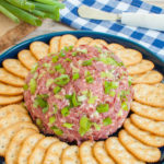 dried cheese ball on platter with crackers
